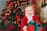A joyful child writing a letter to Santa at a festive desk filled with holiday decorations.