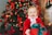A joyful child writing a letter to Santa at a festive desk filled with holiday decorations.
