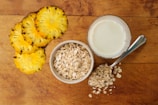 white ceramic bowl with white liquid beside yellow flower