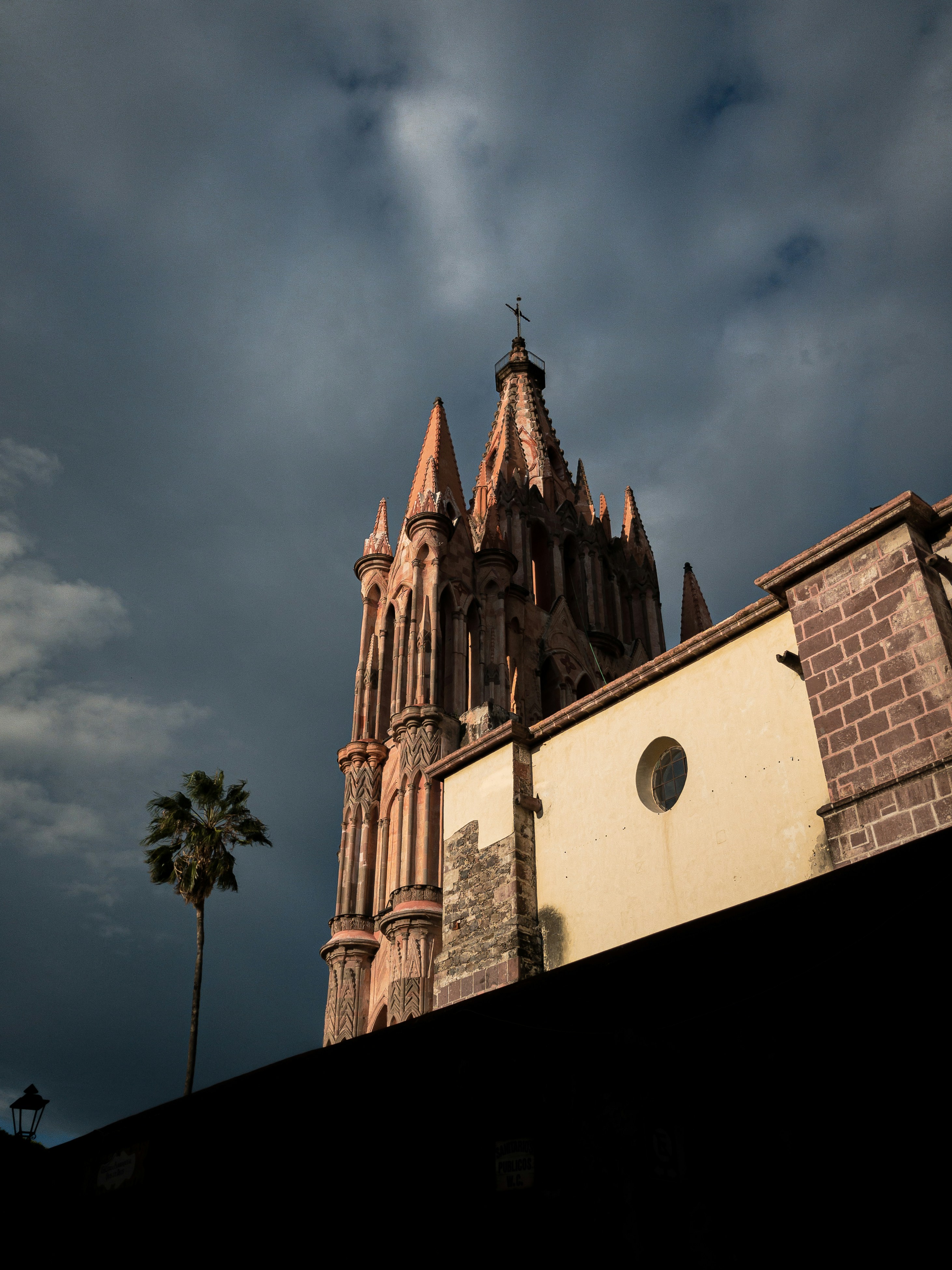 brown concrete building under cloudy sky during daytime