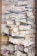 A large collection of boarding passes pinned to a corkboard, arranged in a slightly overlapping manner with colorful pushpins. The tickets display a variety of colors and text in different languages, indicative of multiple flights and destinations.