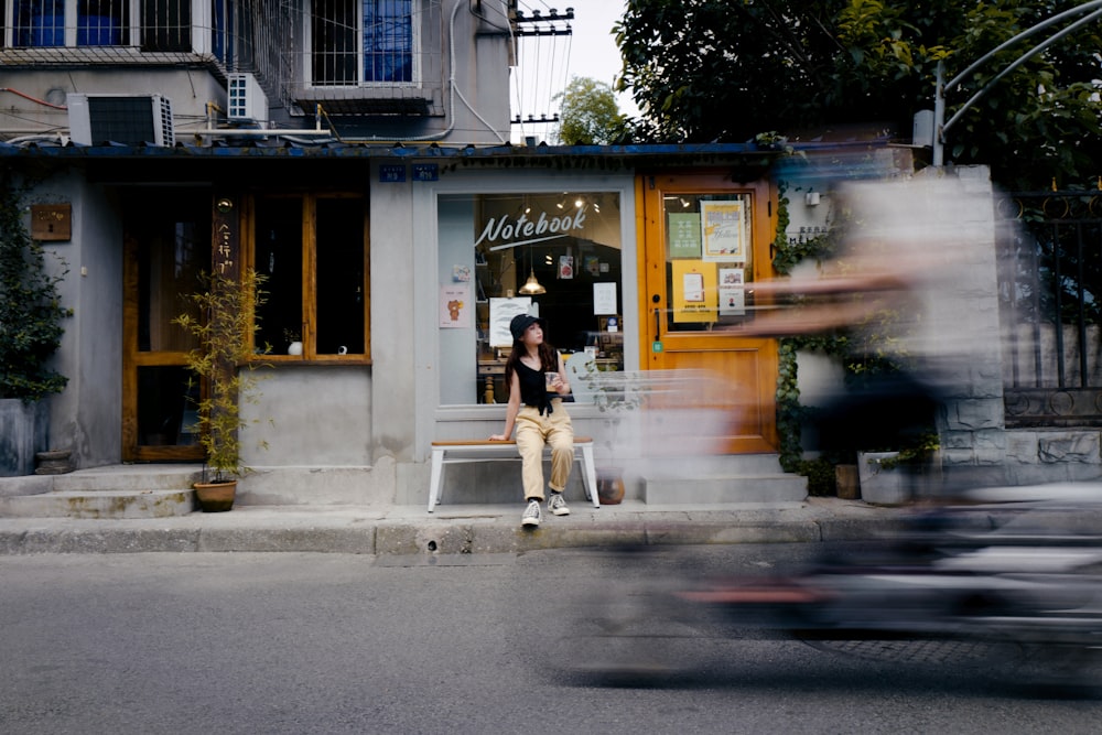 man in white shirt and blue denim jeans walking on sidewalk during daytime