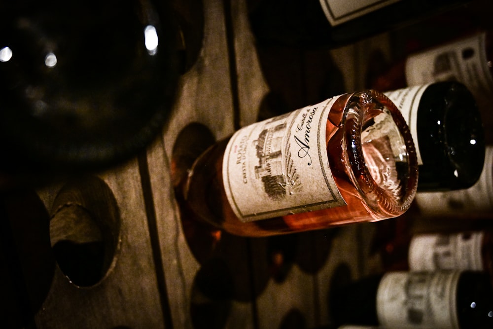 brown glass bottle on brown wooden table