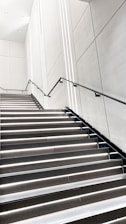 A clean staircase in a modern building with bright lighting.