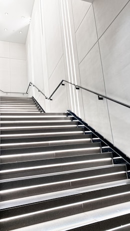 A clean staircase in a modern building with bright lighting.