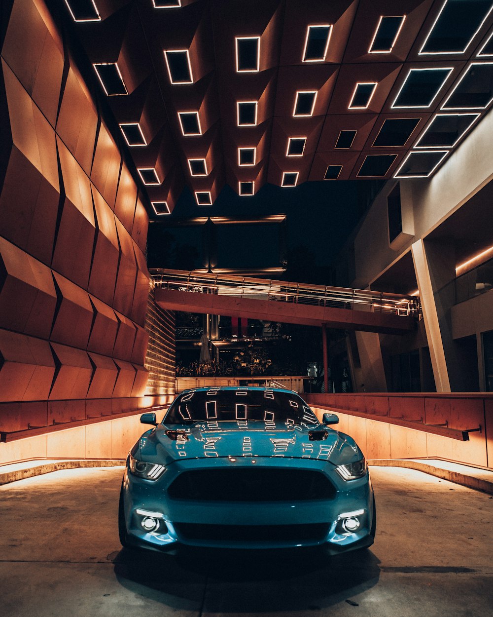 blue car parked in front of building