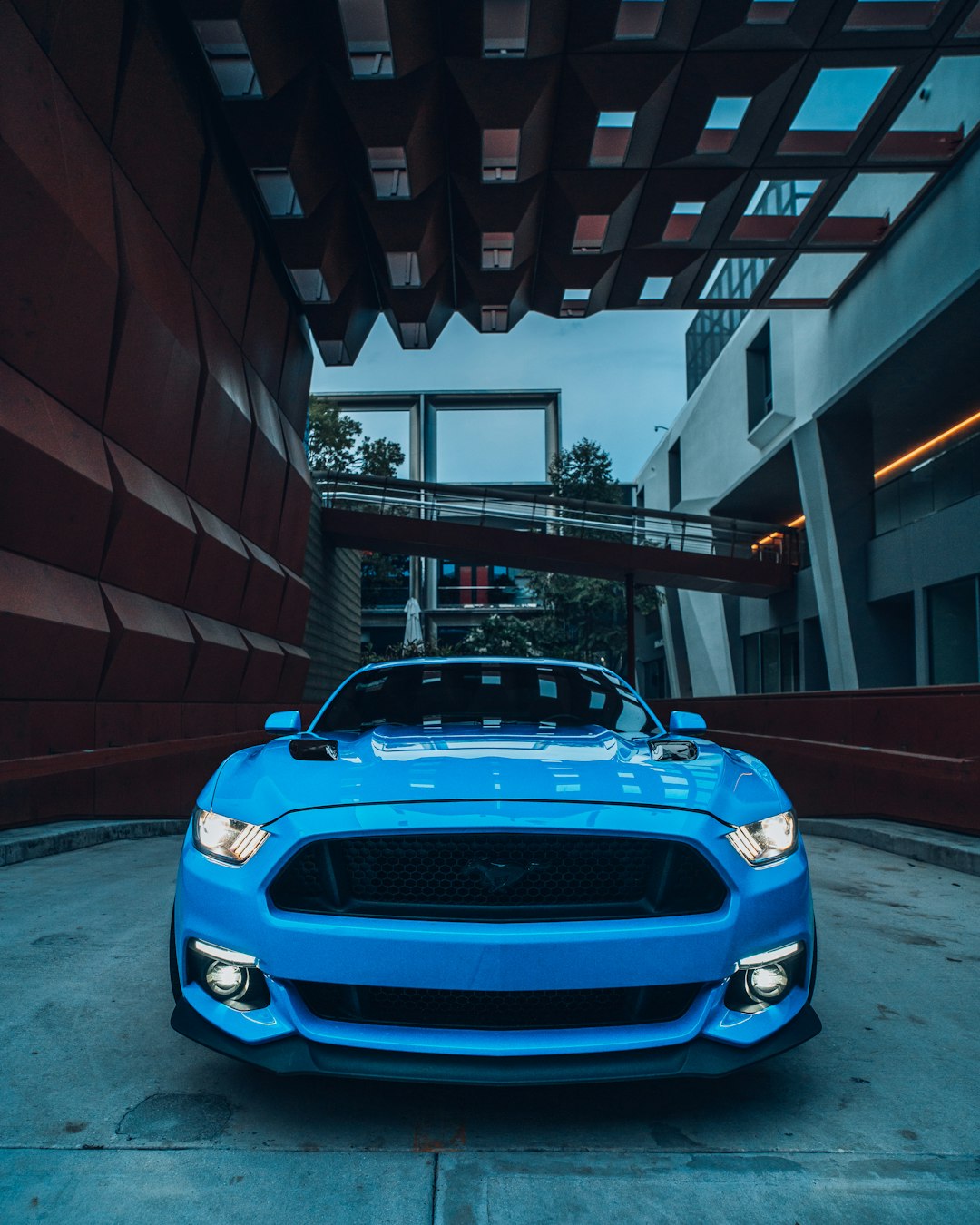 blue bmw m 3 parked in front of brown brick building