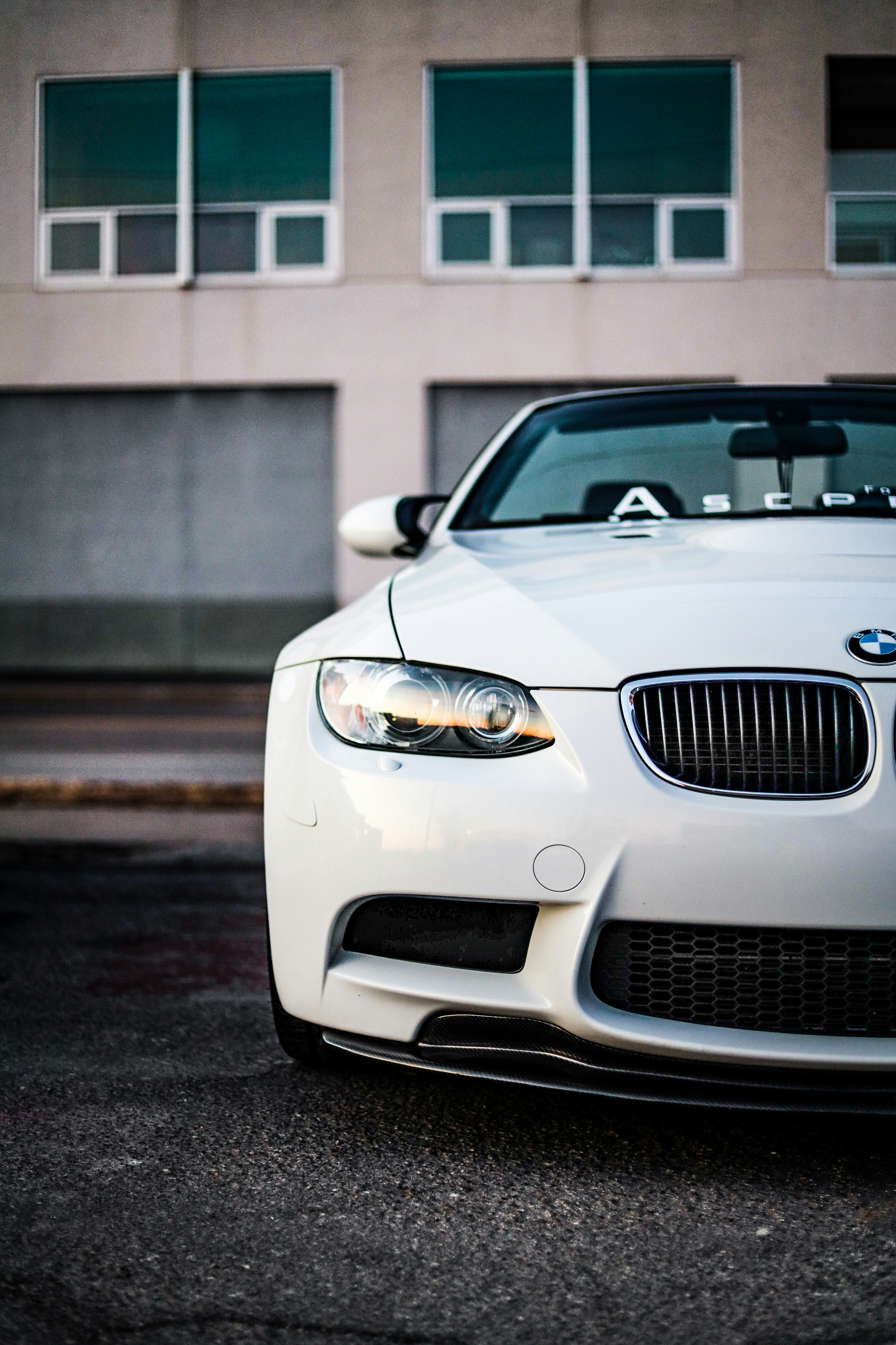 white bmw m 3 parked on street during daytime