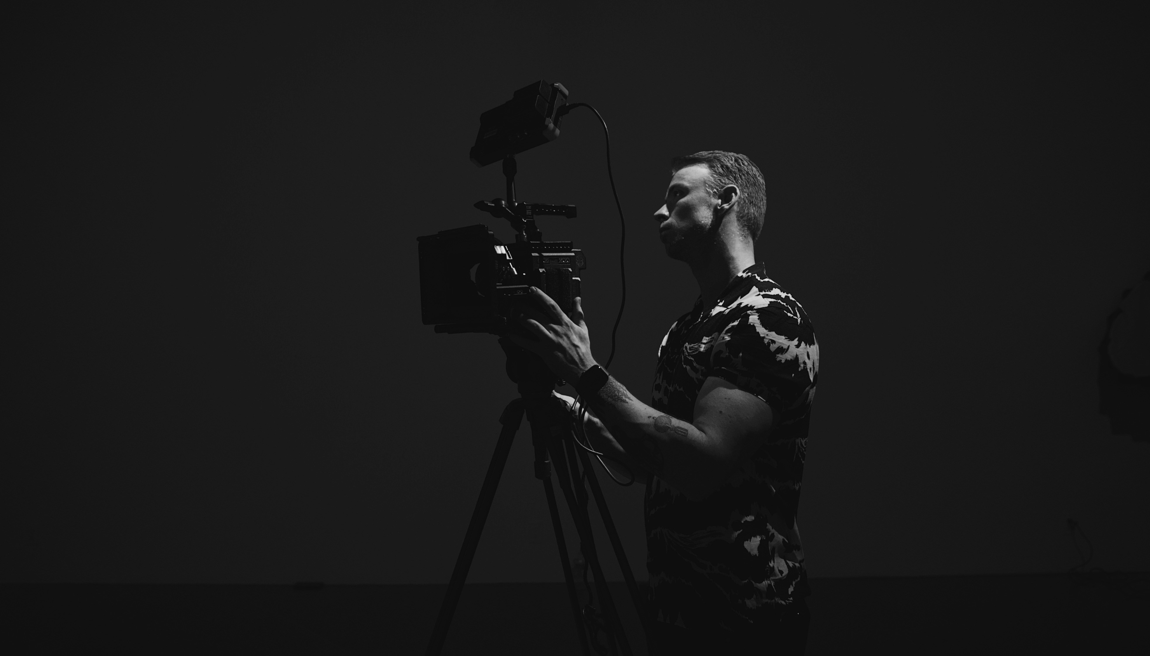 man in black and white crew neck t-shirt standing and singing