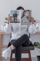 woman in white long sleeve shirt and black pants sitting on chair