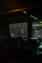 Uniformed security personnel monitoring surveillance cameras indoors.