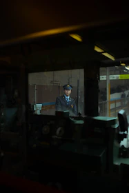 Uniformed security personnel monitoring industrial premises at night.