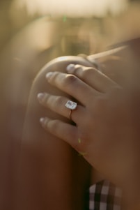 person wearing silver diamond ring