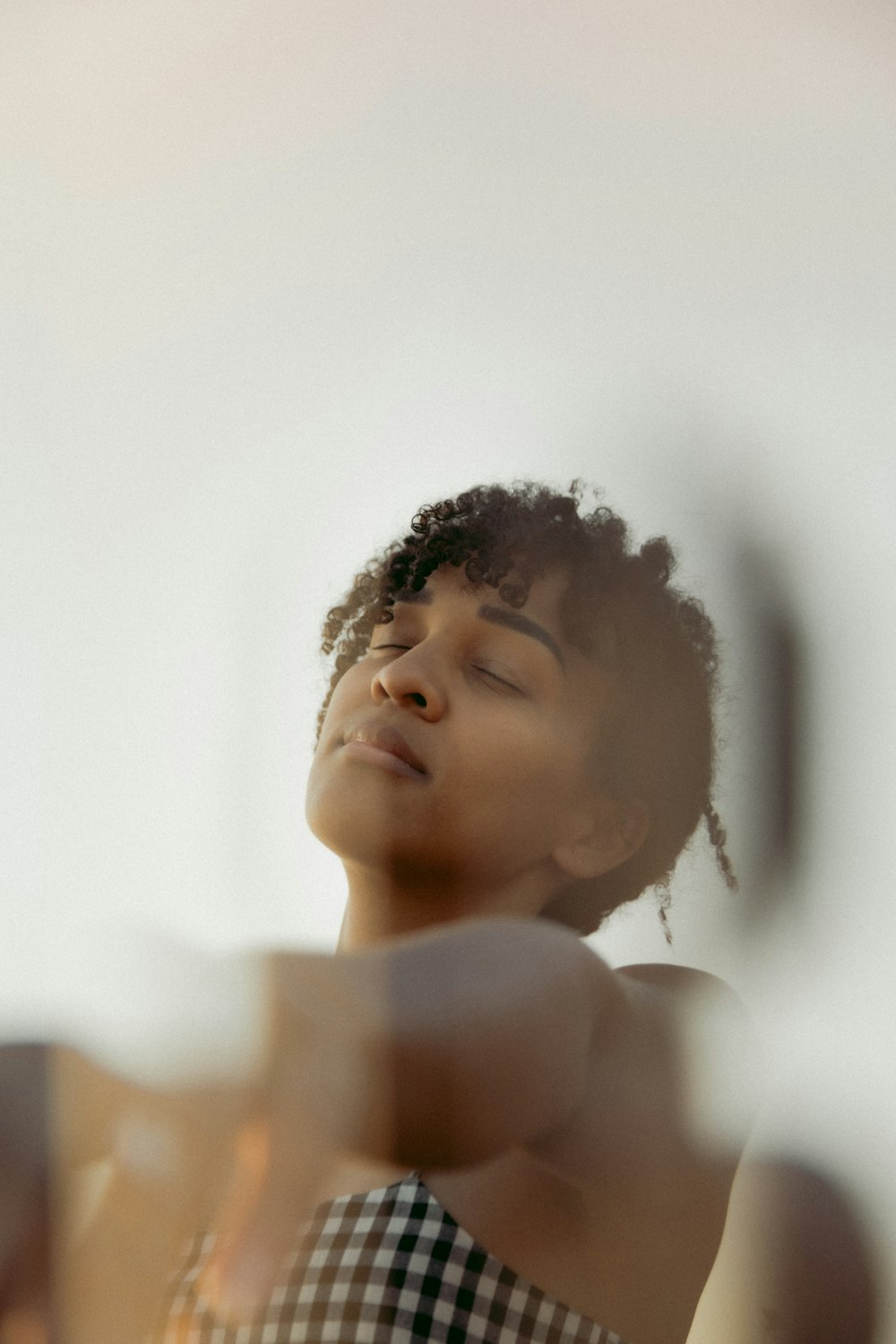 topless woman standing near white wall