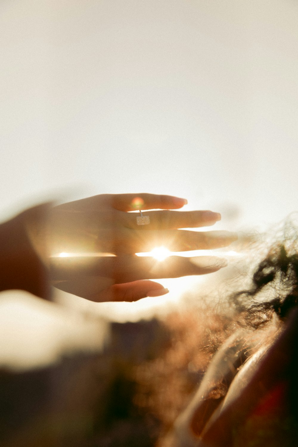 person holding gold band ring