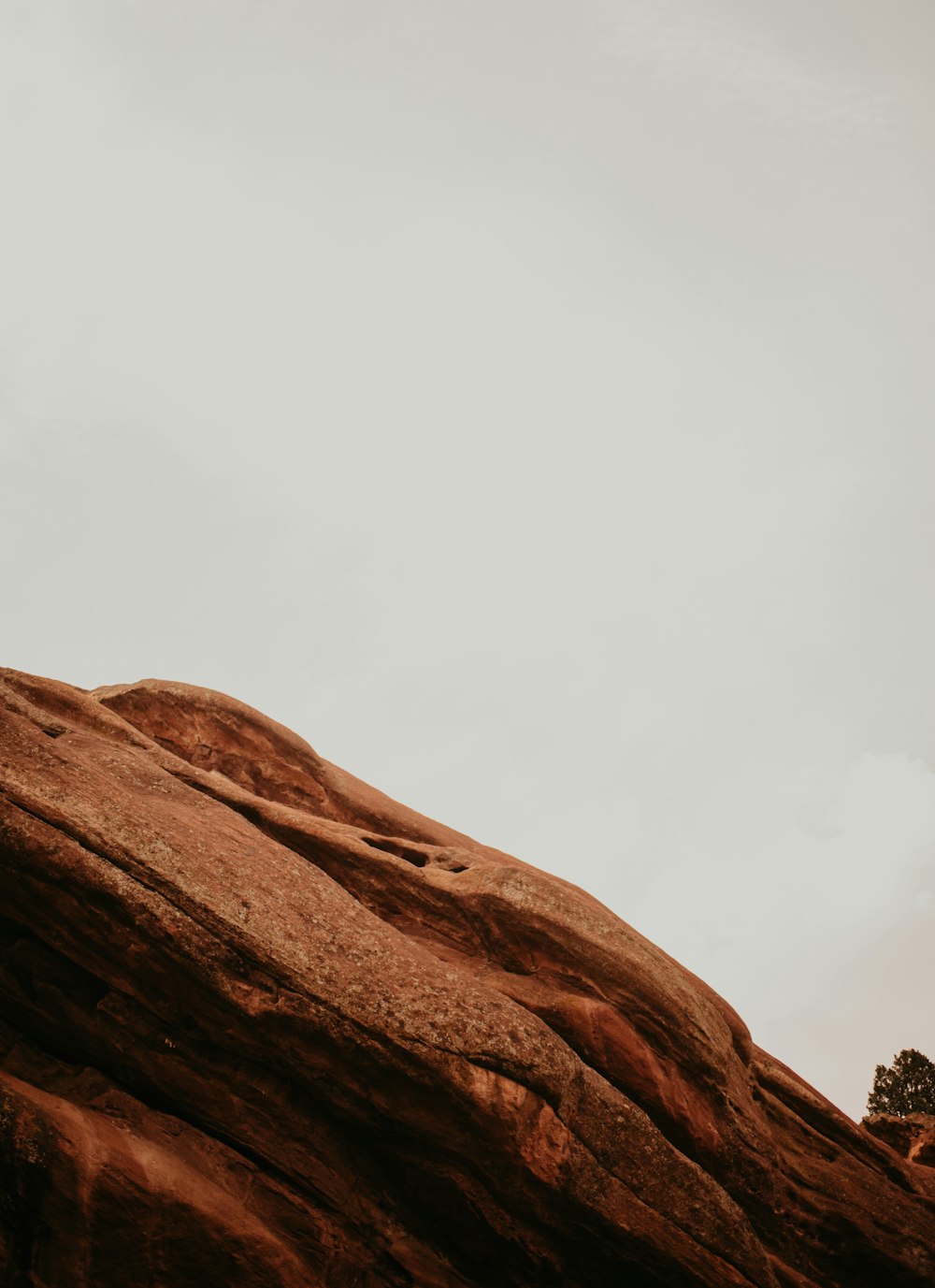 brown rock formation under white sky during daytime