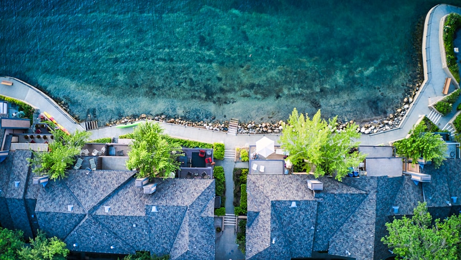 Aerial view of shoreline homes along a curving lakeside road