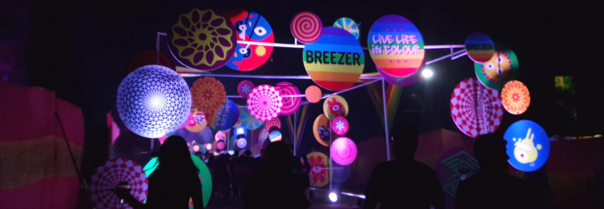 A cheerful team installing a vibrant LED display outdoors on a sunny day.
