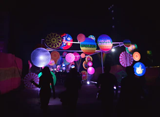 A cheerful team installing a vibrant LED display outdoors on a sunny day.