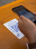 person holding white and black card