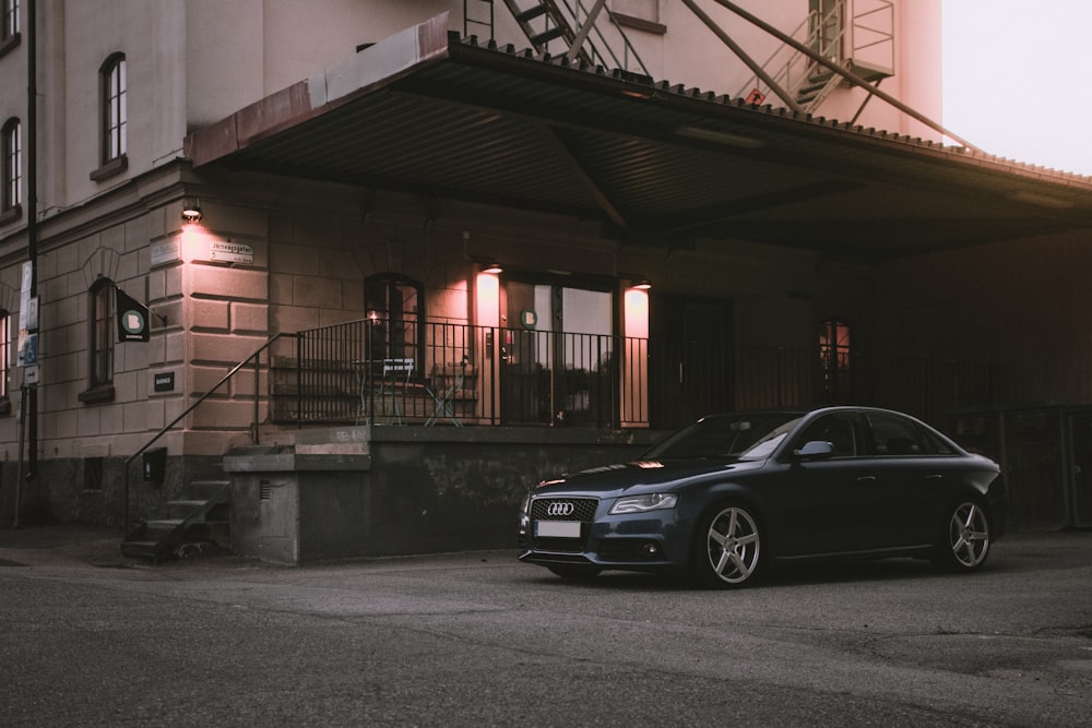 black sedan parked near building