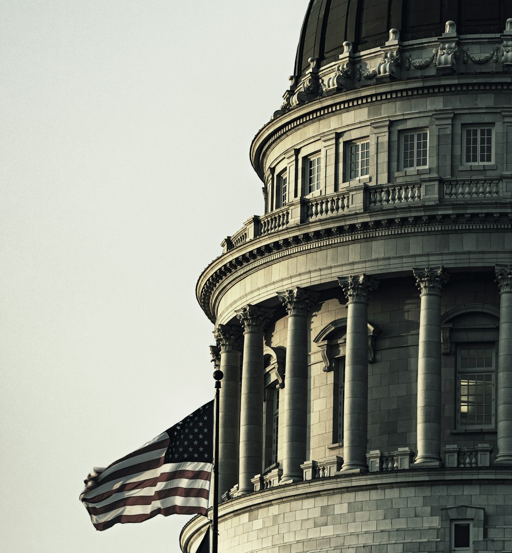 us a flag on top of gray concrete building