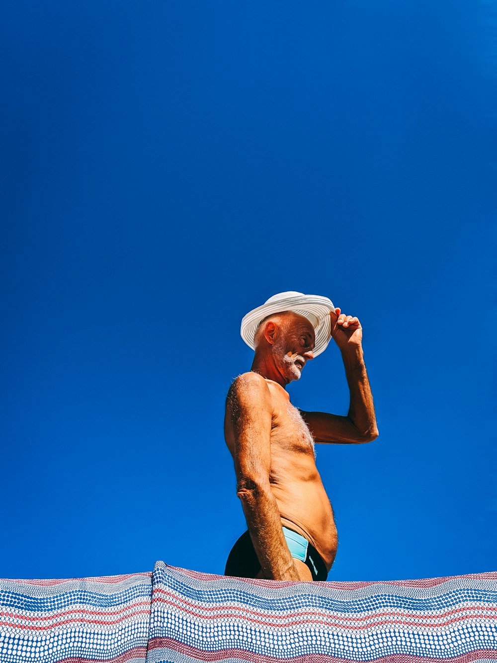 man in white hat and black shorts