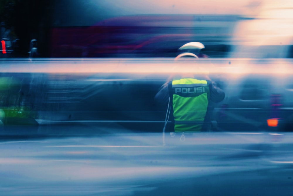 man in green and black jacket wearing white helmet