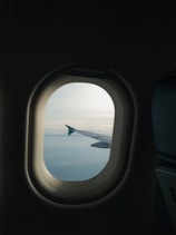 a view of the wing of an airplane through a window
