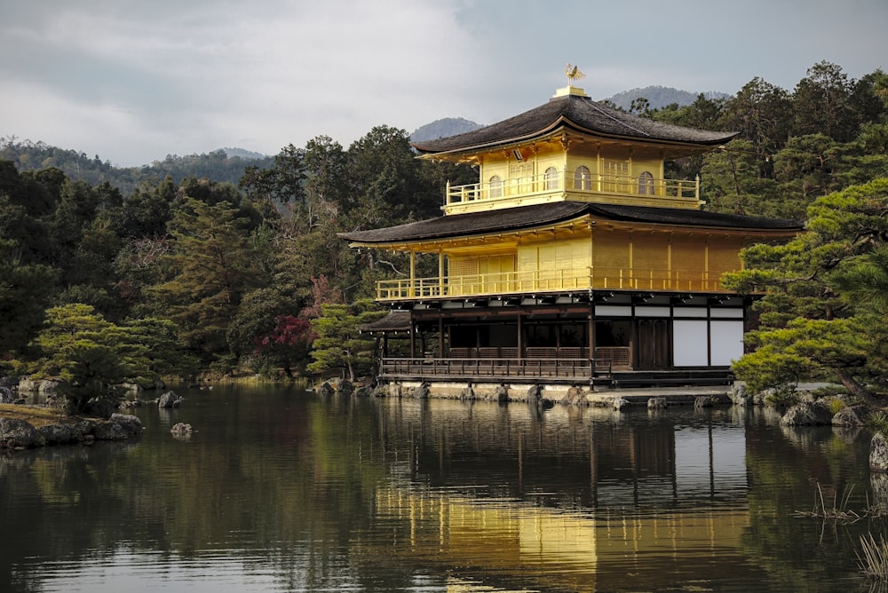 brown and white wooden house near body of water during daytime