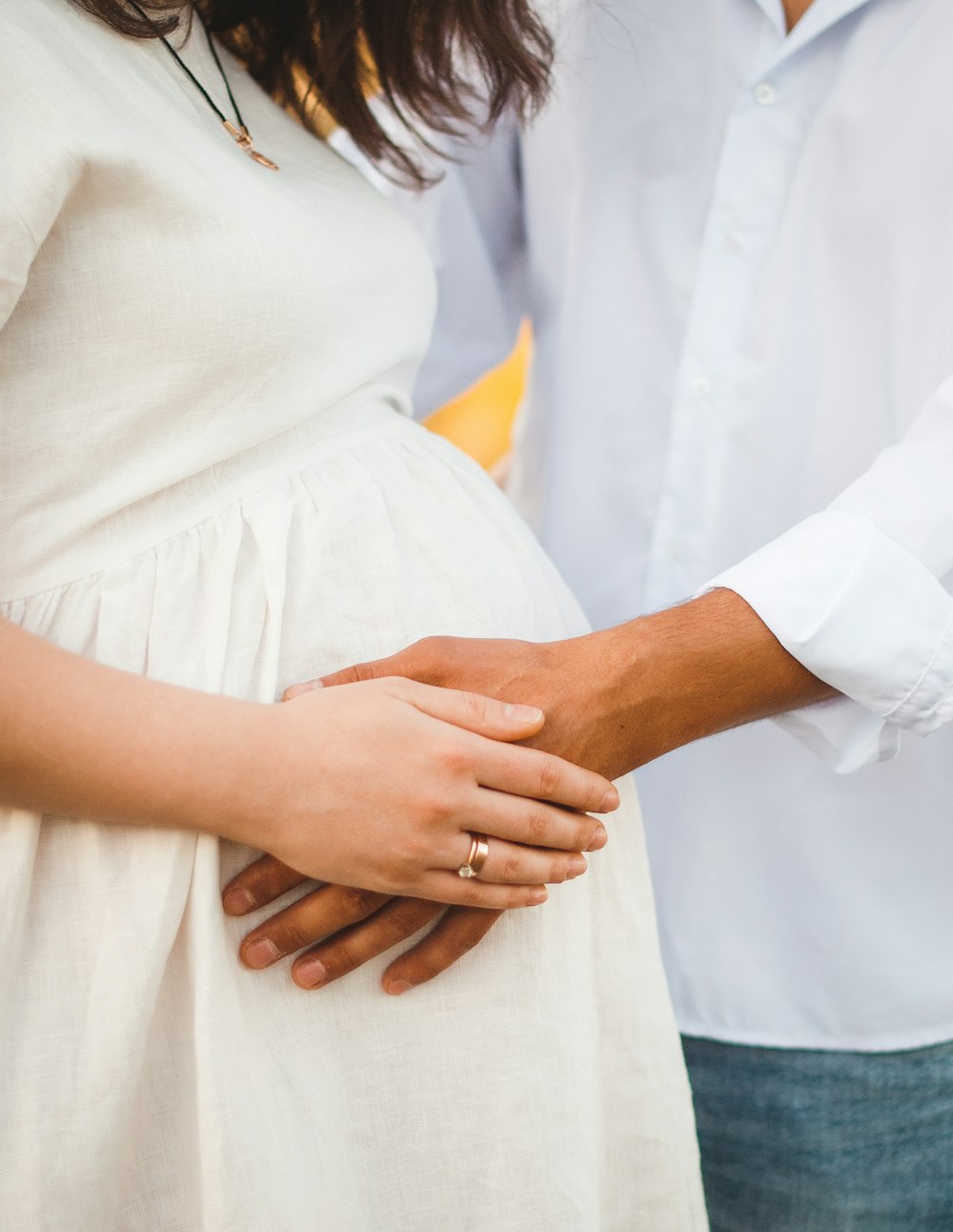 man in white button up shirt holding womans hand