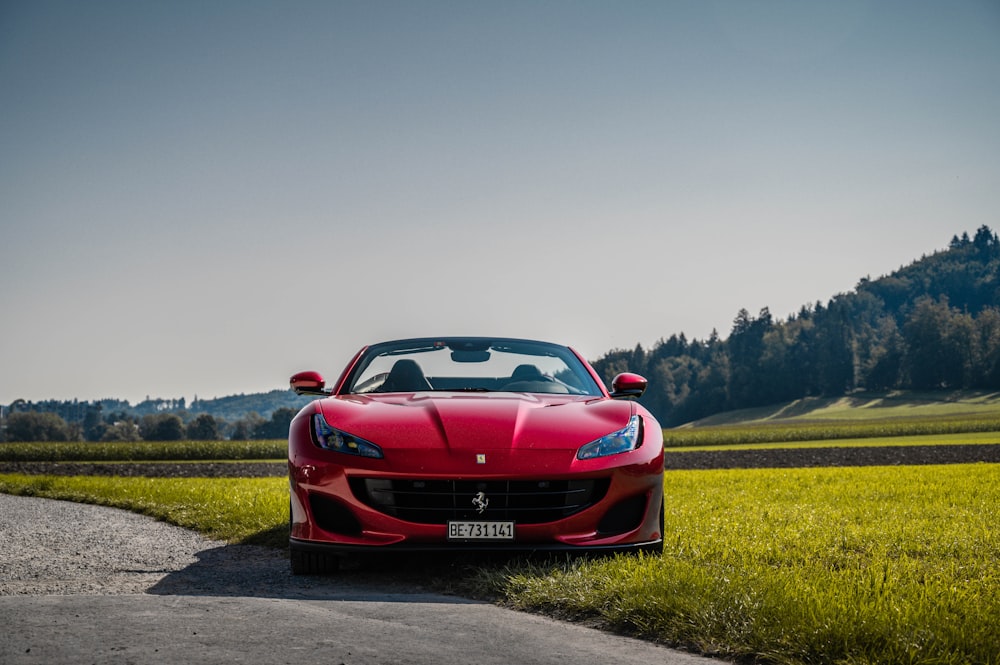 red ferrari sports car on road during daytime