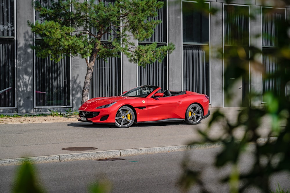 red ferrari 458 italia parked on sidewalk during daytime