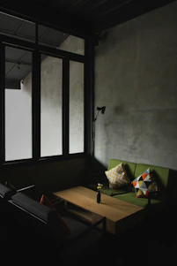A softly lit, minimalist living room showcasing natural textures and clean lines.