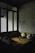 Cozy, minimalist living room with natural linen tones and black accents reflecting Japandi style.