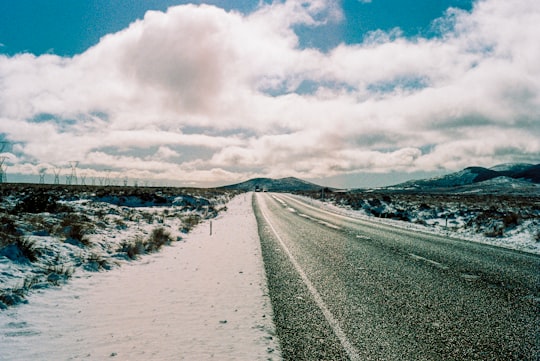 snow covered road under cloudy sky during daytime in Mount Ruapehu New Zealand