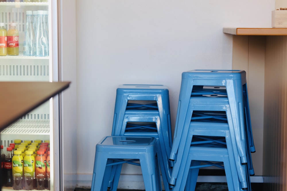 blue plastic chairs beside brown wooden table