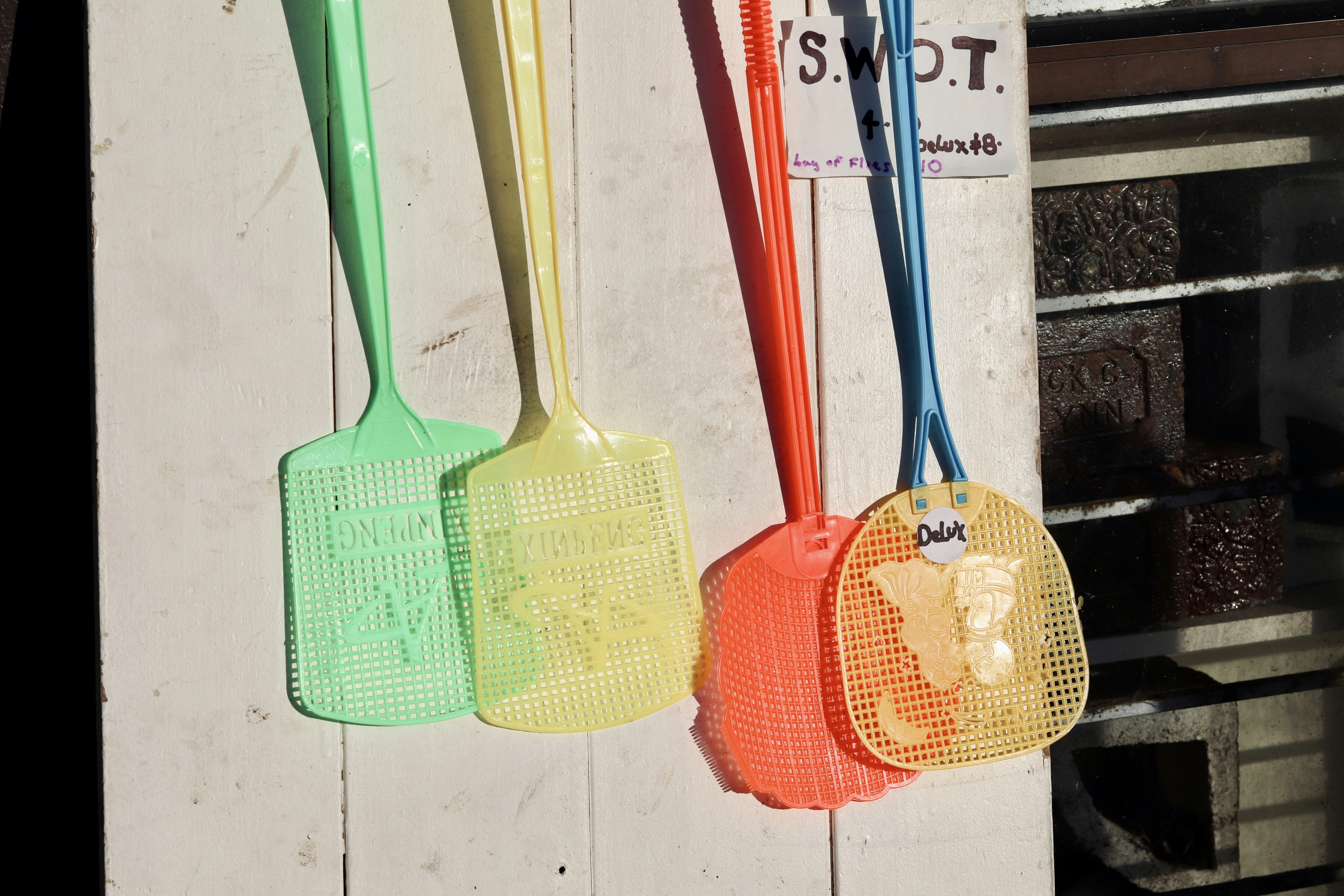 red and yellow wooden guitar and green and yellow stick