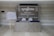 A welcome area with a large sign featuring the logo 'syngenta' and a message for business partners and country leadership team is displayed on a wall. There is a seating plan on a wooden easel to the left, and a table with wrapped items in front of the sign.