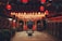 A richly decorated interior space is filled with rows of hanging red lanterns casting a warm glow. Stone statues of mythological creatures guard a central altar, surrounded by intricate carvings and traditional architecture. The atmosphere is serene and reverent.