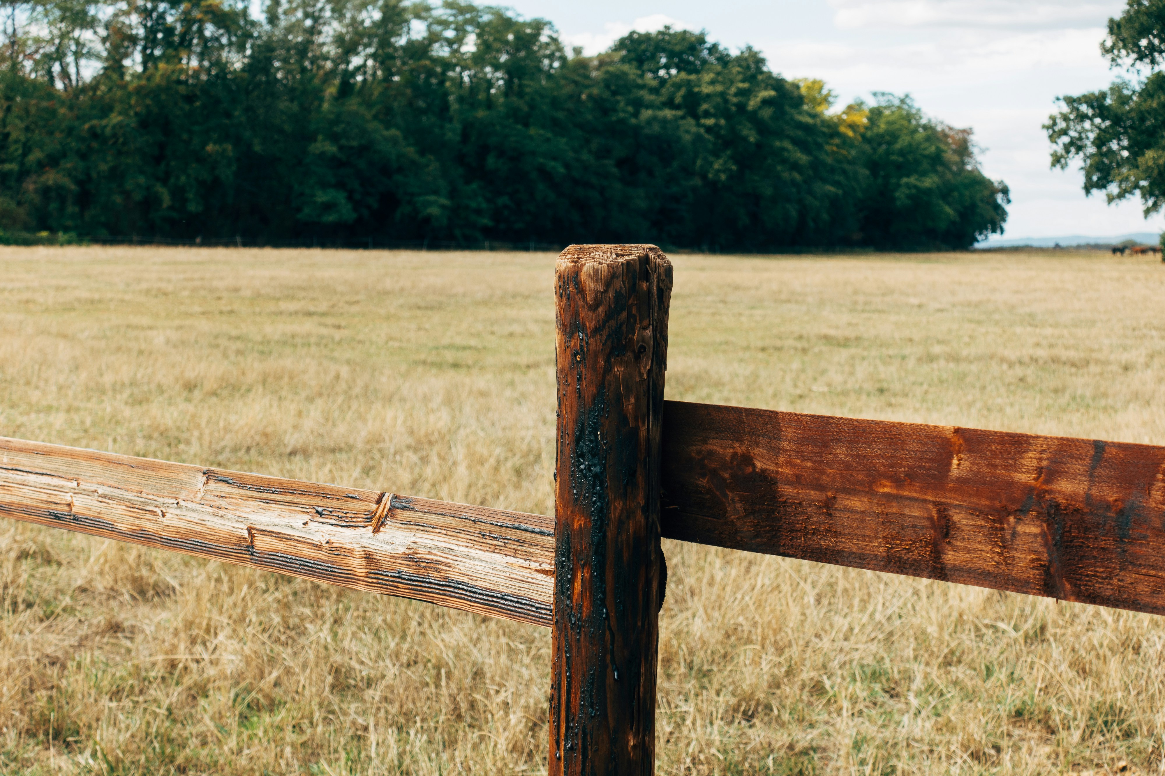 Technician repairing a damaged wooden fence section in Tennessee