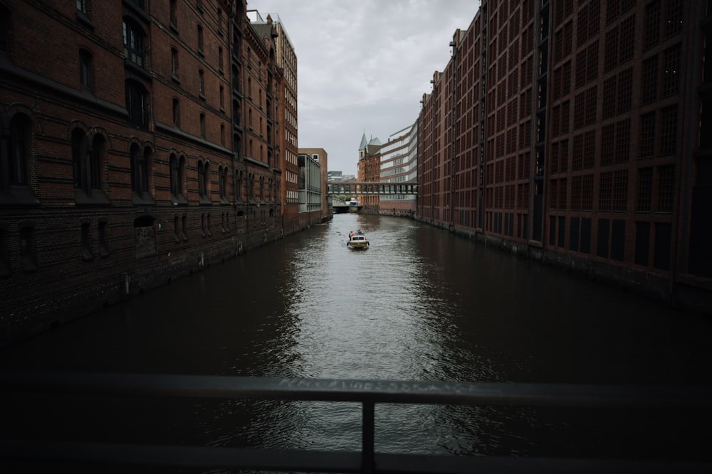 brown concrete building beside river during daytime