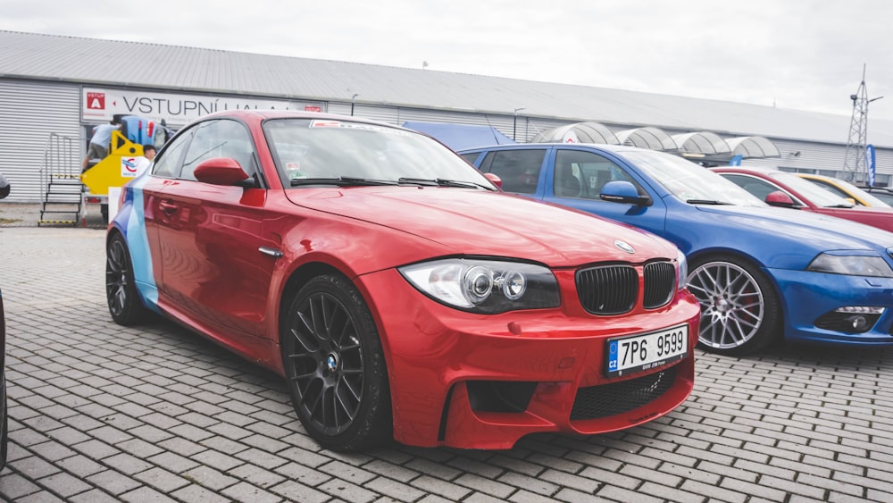 red bmw m 3 coupe parked on parking lot during daytime