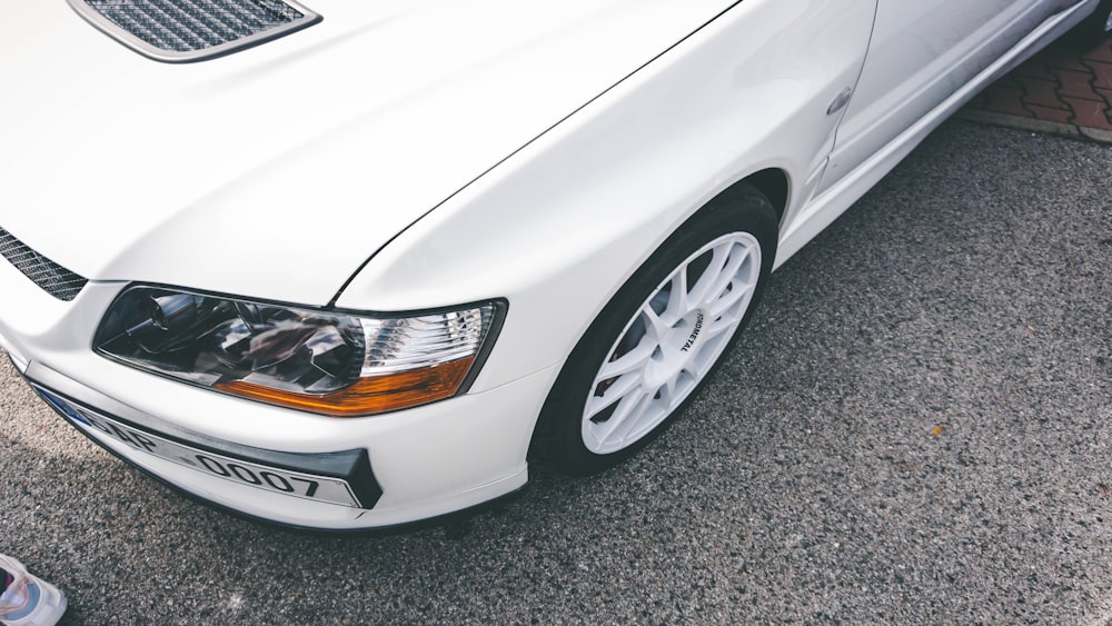 white car on gray asphalt road