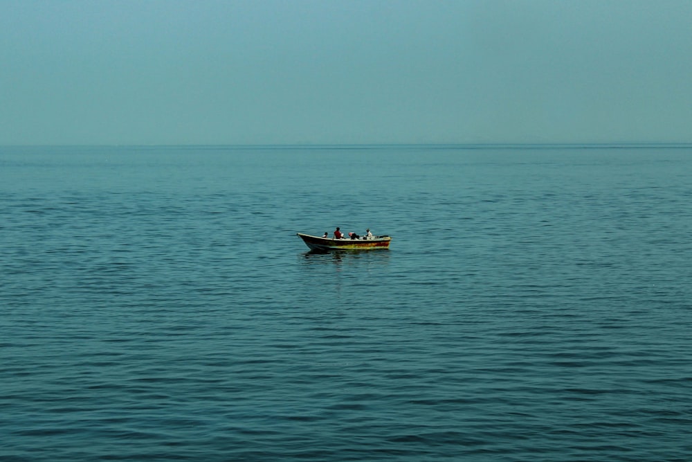 brown boat on sea during daytime