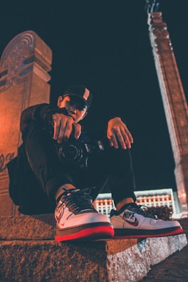 Urban explorer wearing lunakicks sneakers during twilight.