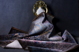 Finished custom rug with rich textures and subtle gold highlights displayed elegantly.