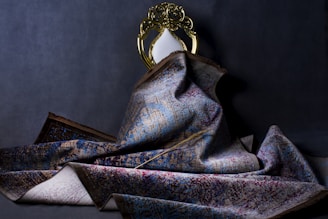 gold and blue ribbon on gray textile