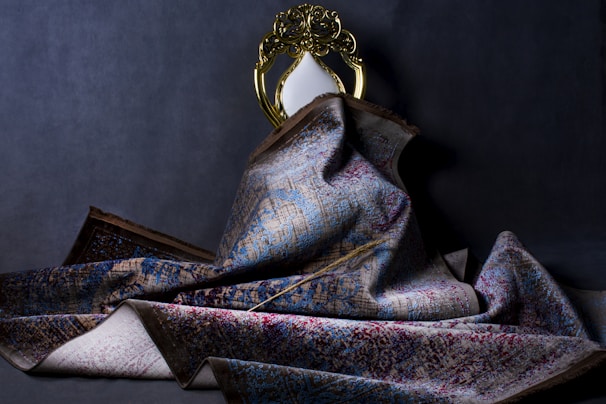 gold and blue ribbon on gray textile