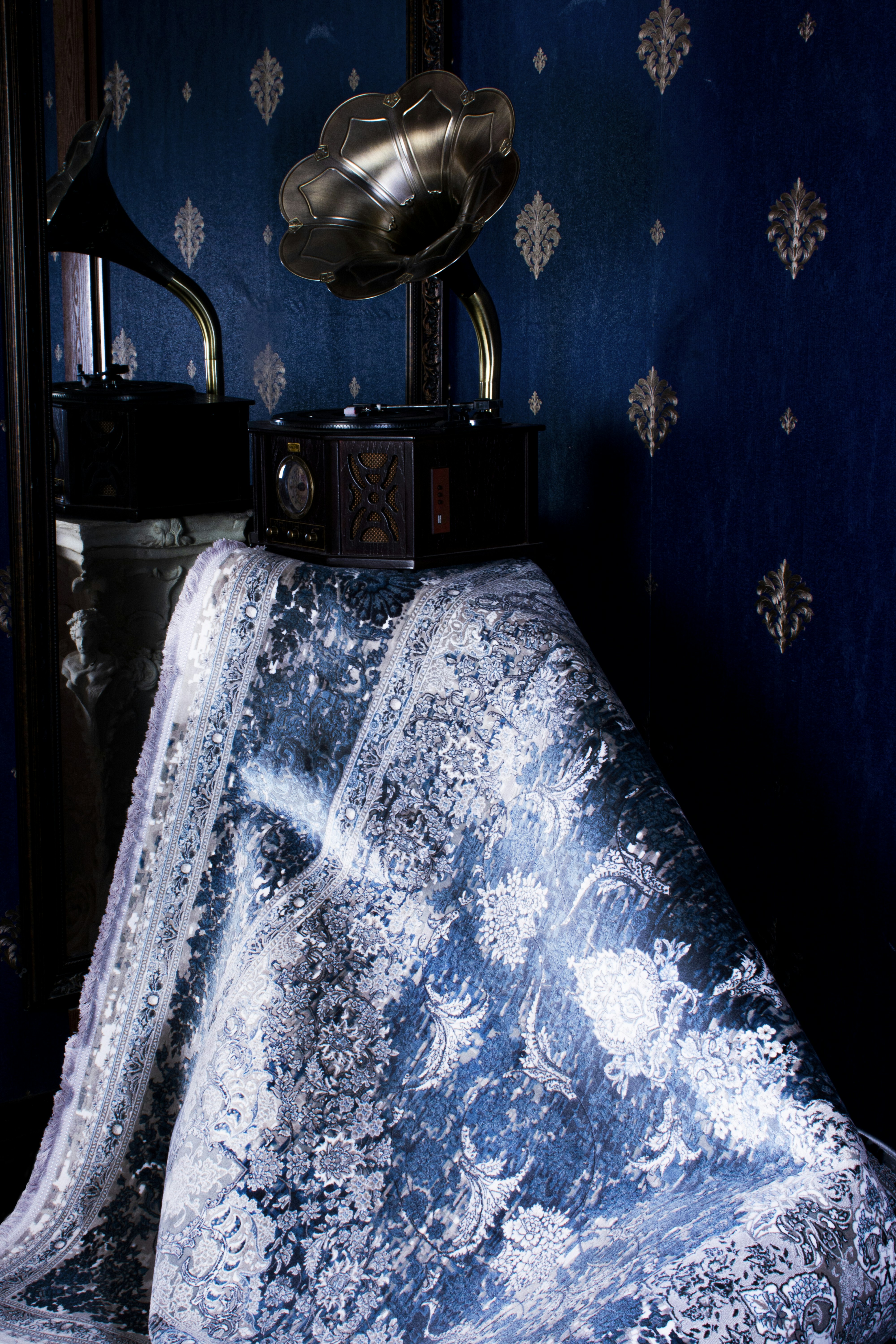 Various colorful carpets displayed in a store